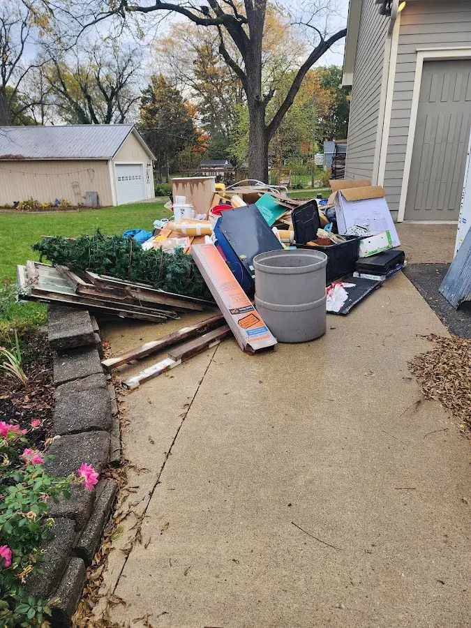 Dumpster being loaded with debris for 12 Yard Dumpster Rental in Nashua